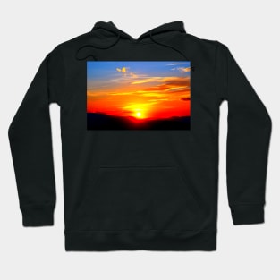 Dramatic sunset on the red-blue sky with the setting sun and clouds Hoodie